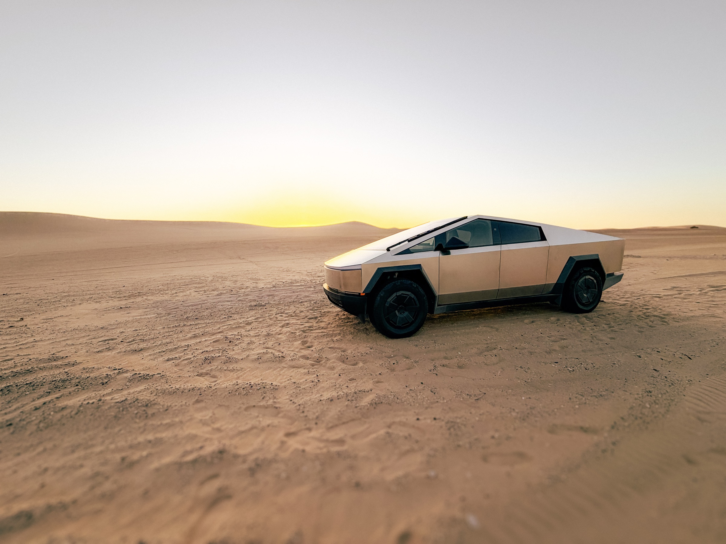 Weekend Gold Cybertruck in the desert at sunset